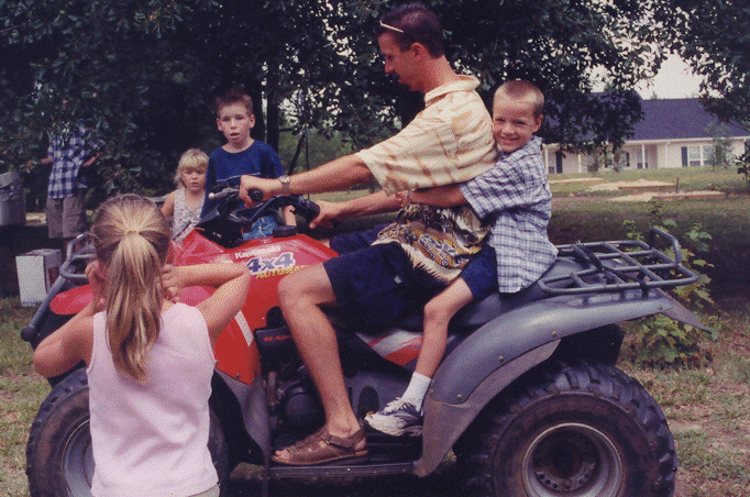 Tom on the 4-wheeler ATV at Grandma Peggy's 90th